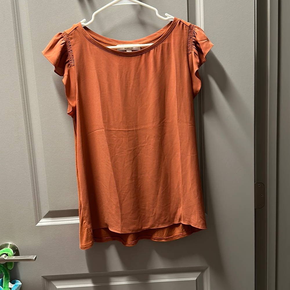 Loft business-casual top. Orange/copper. Short sleeve with cute ruffle shoulder.